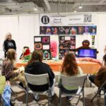 Women presenting to a group of kids about the Cumberland Theatre.