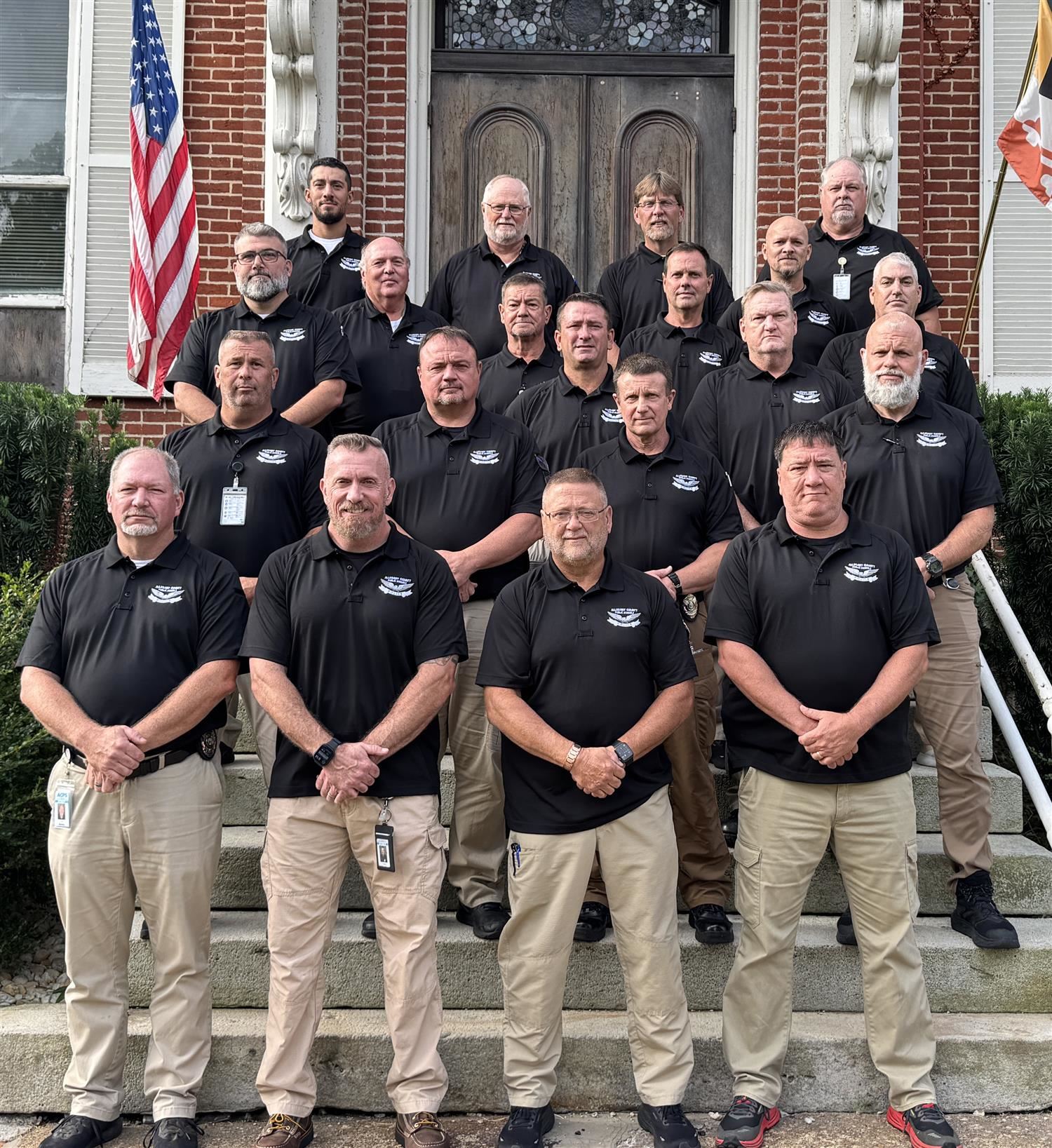 Group of men lined up on stairs for photo.