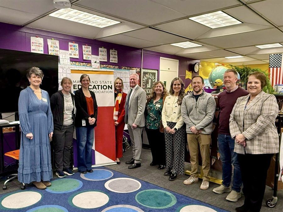 Group photo of adults in a classroom setting.
