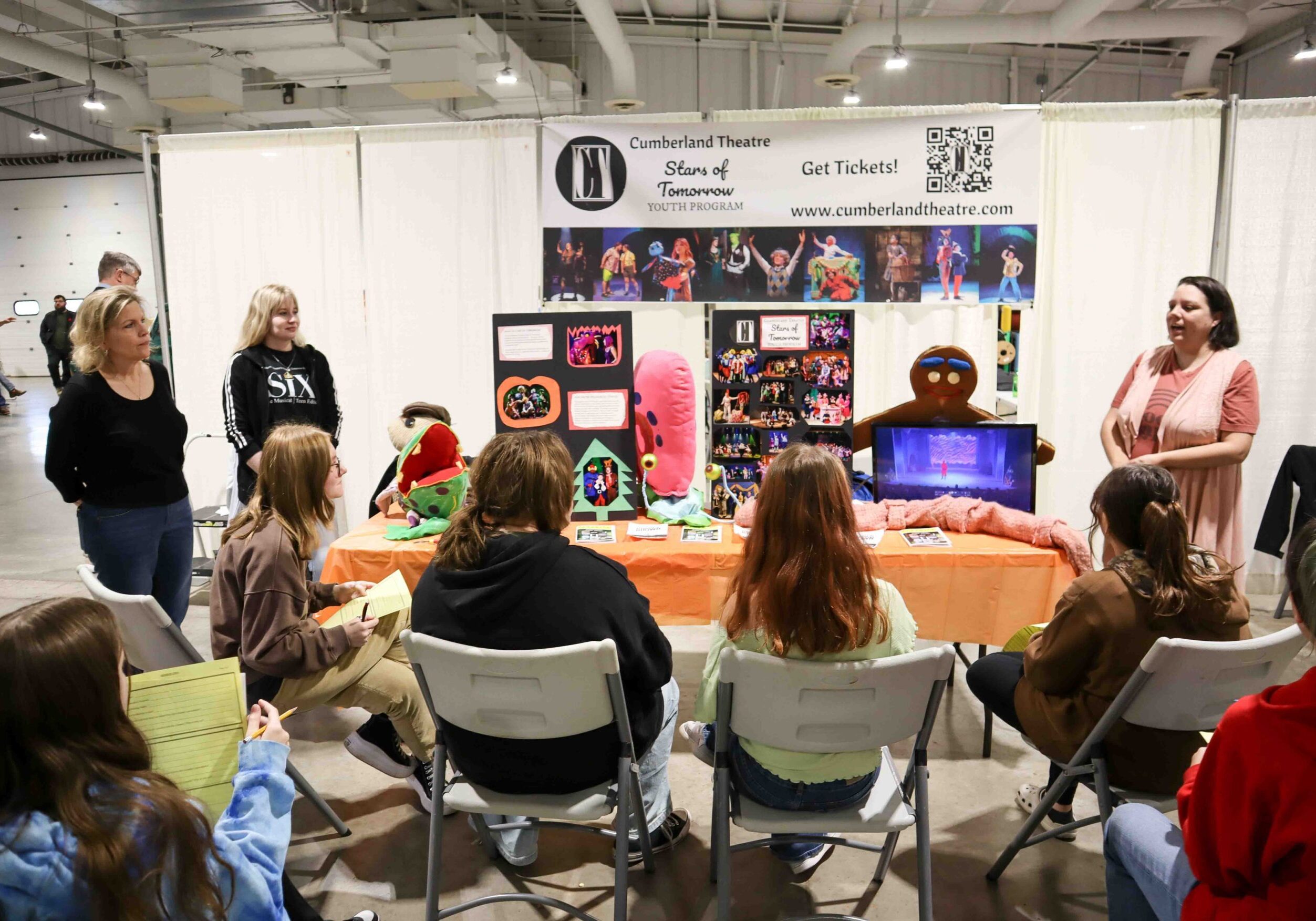 Women presenting to a group of kids about the Cumberland Theatre.