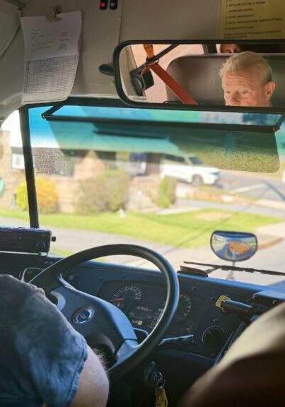 A school bus driver sits in traffic behind another school bus.