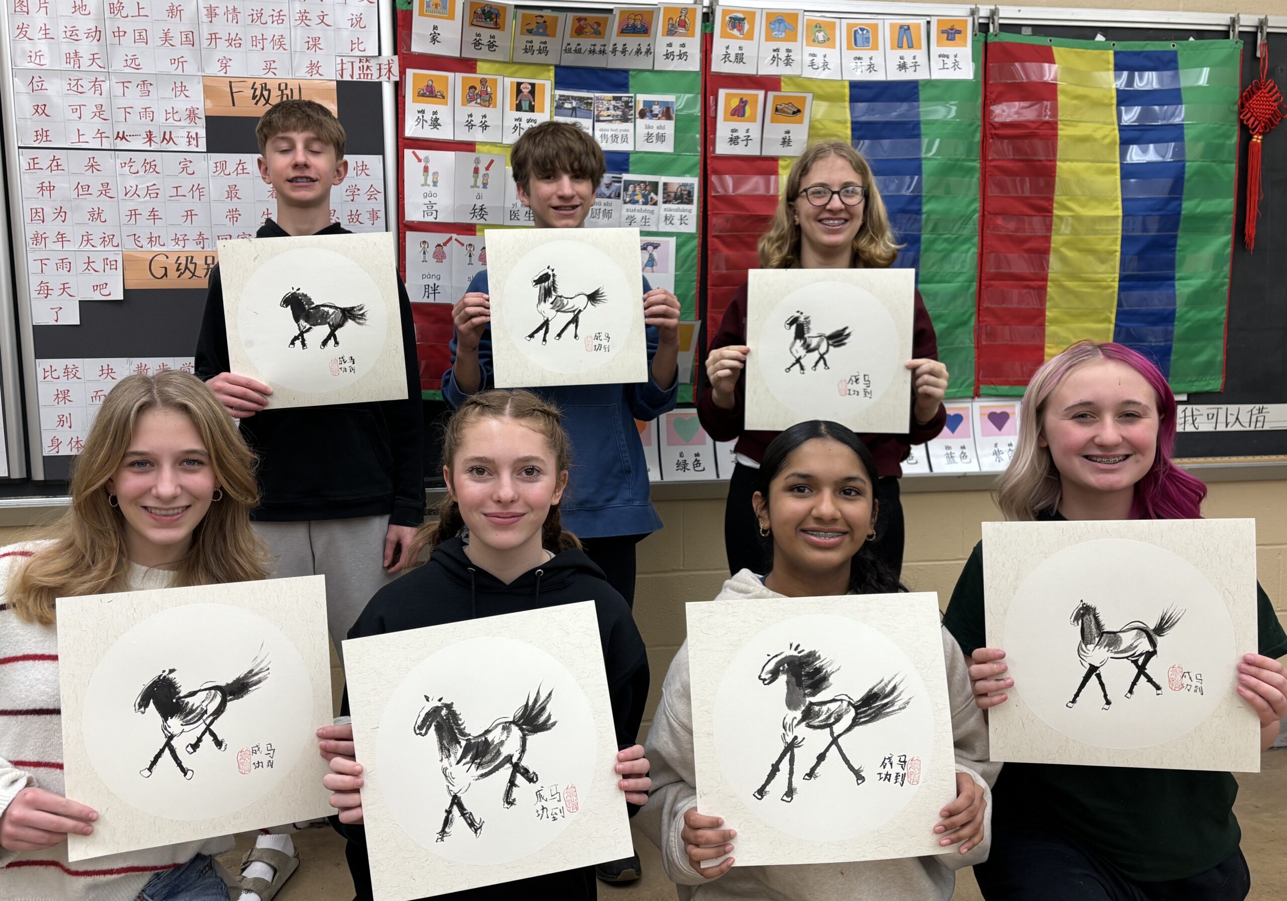 Group of kids holding their art of the 'Fire Horse" for the Chinese Lunar New Year.