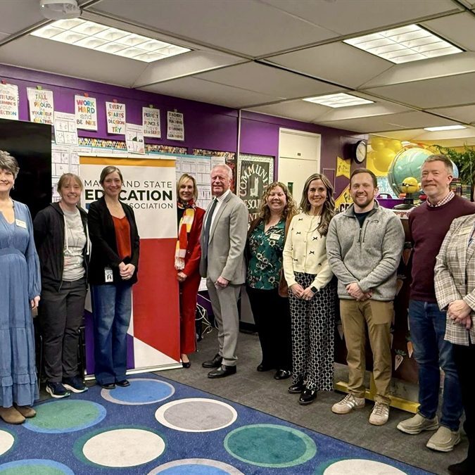 Group photo of adults in a classroom setting.